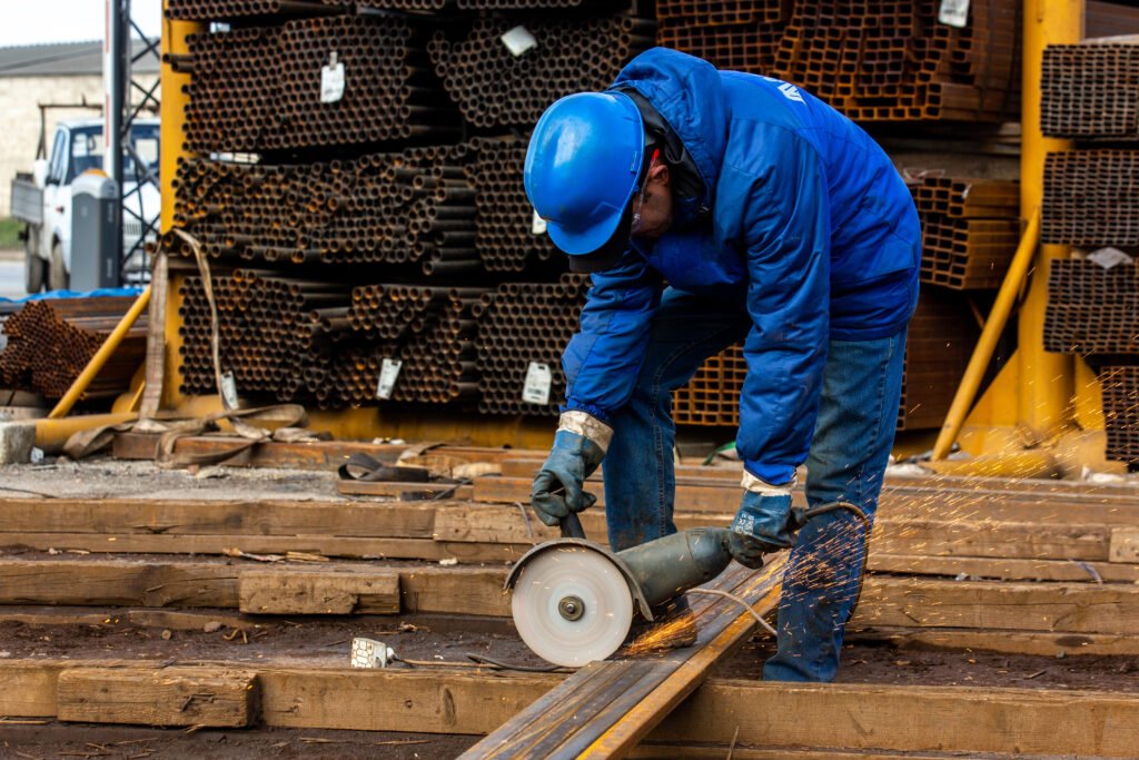 worker cuts iron with tool worker cuts iron with tool